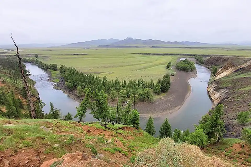 The Orkhon River winding through green steppe below Uurtiin Tokhoi in Central Mongolia