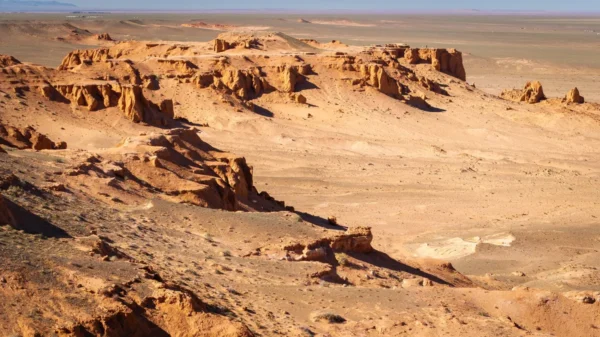 Red sandstone cliffs and pillars of Bayanzag, the Flaming Cliffs, in the Gobi Desert