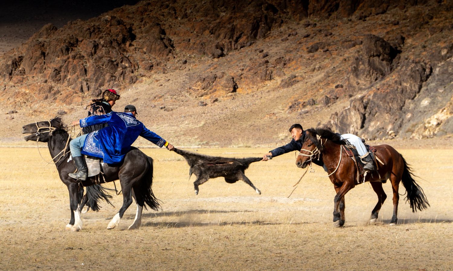 Riders competing in kokpar, a traditional Kazakh horseback game, at the Golden Eagle Festival